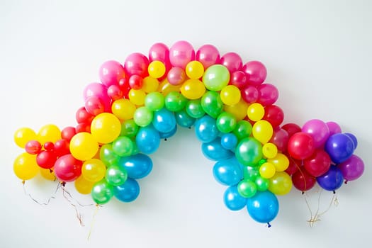 Colorful balloons arranged in the shape of a rainbow, symbolizing hope and positivity