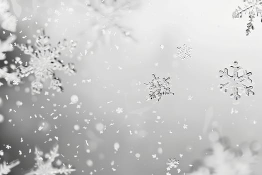Delicate snowflakes falling against a soft transparent white backdrop, perfect for winter scenes