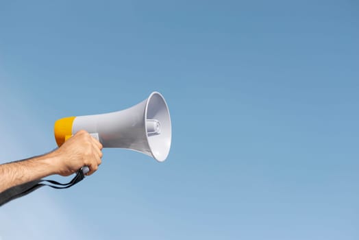 protester holding megaphone demonstration. High resolution photo