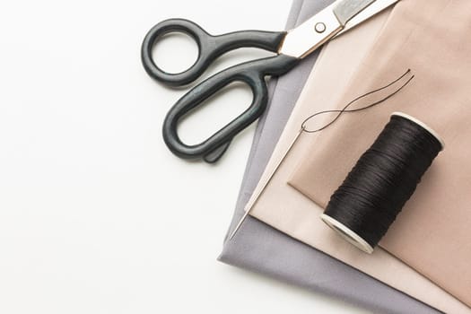top view fabrics with scissors thread. High resolution photo