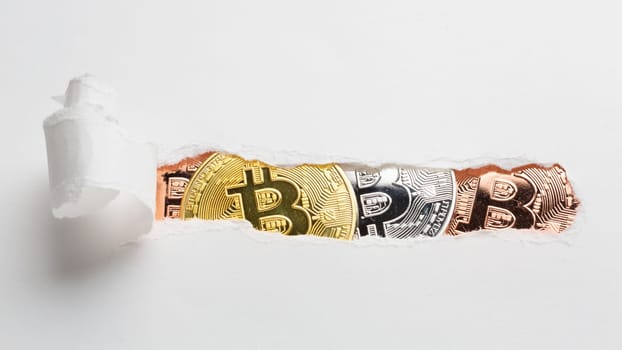 ripped paper revealing bitcoin. High resolution photo