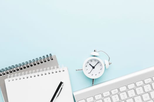 top view notebook clock arrangement. High resolution photo