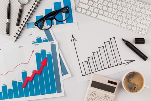 top view office desk with growth chart glasses. High resolution photo