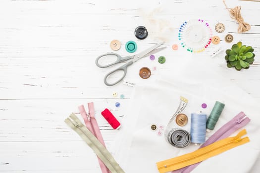 vivid sewing items wooden background. High resolution photo
