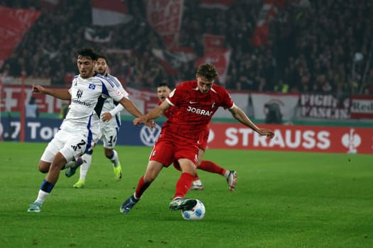 Patrick Osterhage (SC Freiburg) pulls past his opponent William Mikelbrencis (Hamburger SV / HSV) with a step-over in the match for the DFB-Pokal 2024-25,2nd round: SC Freiburg vs Hamburger SV