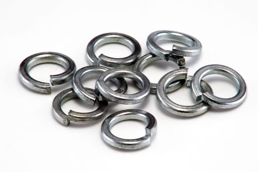 A heap of large split spring washers on white background