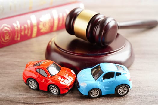 Bangkok, Thailand March 15, 2023 Car accident lawsuit and insurance, Judge hammer with car model.