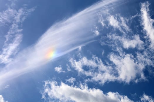 rare meteorological occurrence of a mock sun as it is forming in the clouds