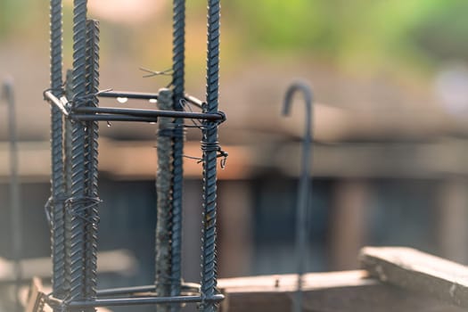 Concrete footings and reinforcing steel rods at a construction site. Groundwork for new building foundation. Reinforcement steelwork providing strength and stability for long term structural integrity