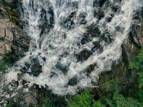 Aerial view of a waterfall in a lush tropical green forest in Doi Inthanon National Park, Chiang Mai, Thailand. This nature landscape showcases water sustainability and scenic travel destinations.