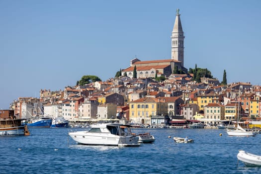 Rovinj, Croatia, Istria - September 29, 2023: Beautiful view from the South port Rovinj over Adriatic Sea to the peninsula with the Old Town and the tower of Saint Euphemia Church