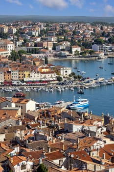Rovinj  Croatia  Istria - September 29  2023: Aerial view from bell tower of Saint Euphemia Church of port with moored boats. Typical red ceramic roof tile