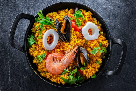 Seafood paella served in a cast iron pan.
