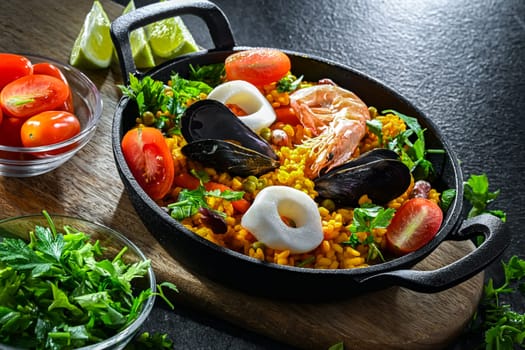 Seafood paella served in a cast iron pan.