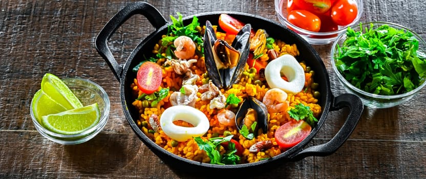 Seafood paella served in a cast iron pan.