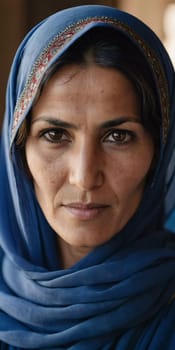 A woman 45 years old in Afghanistan stands confidently, wearing a beautifully patterned scarf. The mountainous landscape emphasizes her strength and connection to her heritage. Generative AI.