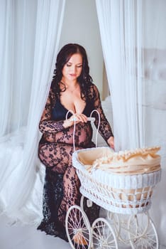 A beautifully stylish and artistic representation of motherhood showcasing a woman with a vintage baby carriage