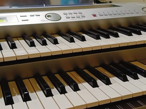 Close-up of an electronic organ in a cozy music room.