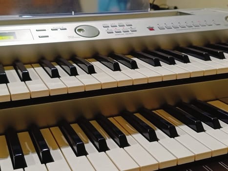 Close-up of an electronic organ in a cozy music room.