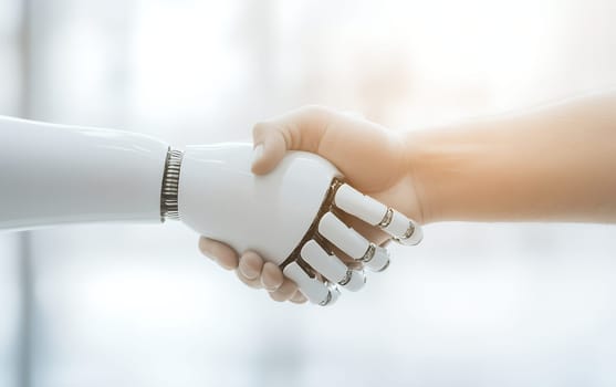 A human hand shakes hands with a robotic hand, symbolizing cooperation between humans and technology.