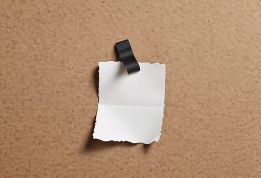 A piece of vintage blank note paper is secured with tape to a textured brown surface, ideal for business communications or reminders, conveying an old-fashioned office style. Generative AI.