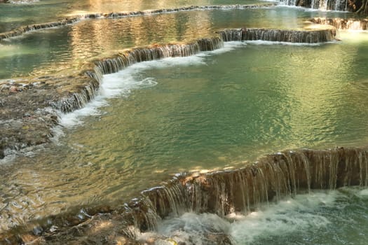 View onto the many pools, lagoons of the Kuang Si Falls, Waterfalls with its bright green water, Luang Prabang, Laos 2023