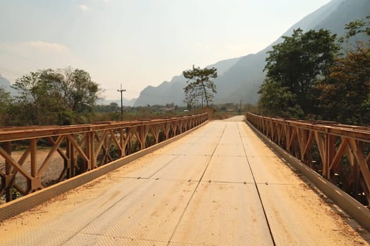 Metal bridge in the rural, remote landscape that surrounds Vang Vieng, Laos 2023