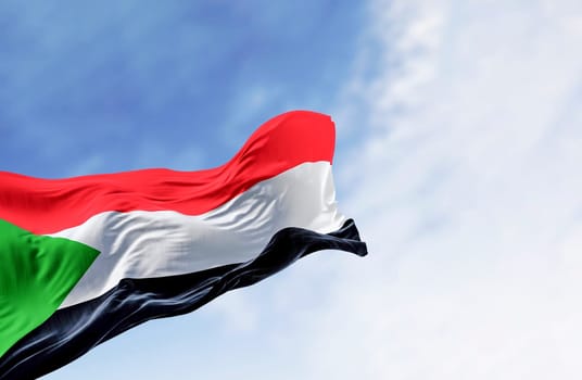 Sudan national flag waving in the wind. Red, white, black horizontal stripes with a green triangle at the hoist. 3d illustration render. Rippling fabric
