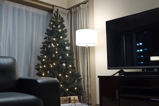 The cozy living room features a beautifully decorated Christmas tree with lights, a lamp casting soft glow, and a television nearby.