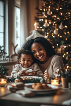 A mother and her young child share a joyful moment near a Christmas tree, surrounded by festive treats and warm candlelight.