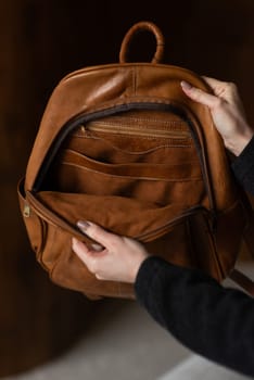 photo of a brown leather backpack with retro look. indoors photo