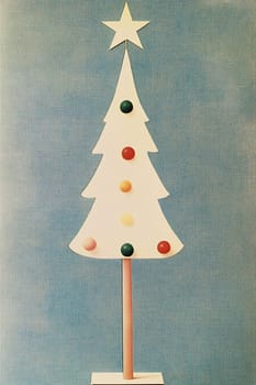 A minimalist Christmas tree with a star on top, decorated with colored dots, stands out against a blue textured backdrop.