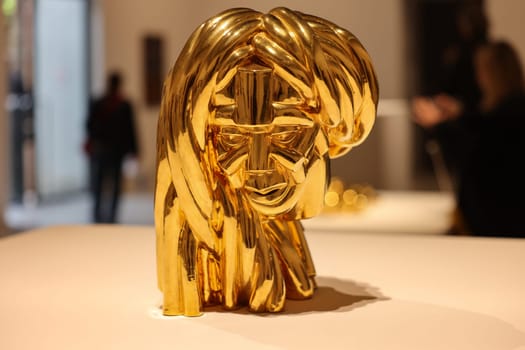 Venice, Italy - May 7 2024: Foreigners Everywhere 60th Venice Art Biennale in Venice. Malinconia by Victor Fotso Nyie. Glazed ceremic and gold.
