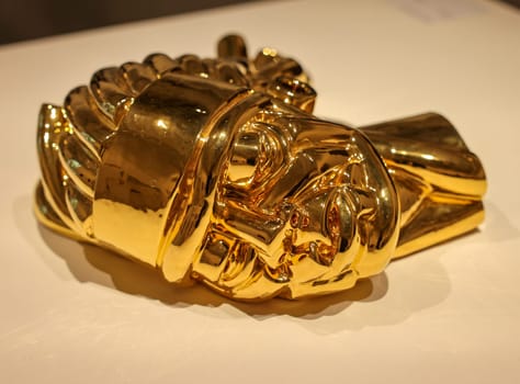 Venice, Italy - May 7 2024: Foreigners Everywhere 60th Venice Art Biennale in Venice. Veglia by Victor Fotso Nyie. Glazed ceremic and gold.