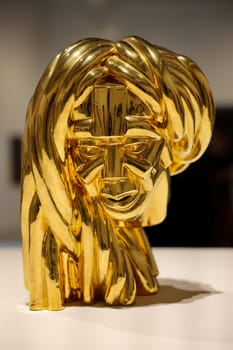 Venice, Italy - May 7 2024: Foreigners Everywhere 60th Venice Art Biennale in Venice. Malinconia by Victor Fotso Nyie. Glazed ceremic and gold.