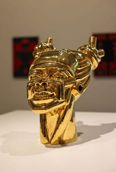 Venice, Italy - May 7 2024: Foreigners Everywhere 60th Venice Art Biennale in Venice. Gioia by Victor Fotso Nyie. Glazed ceremic and gold.