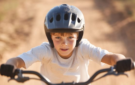 Focused young boy wearing a helmet while riding his bicycle on a dirt path, showcasing determination.