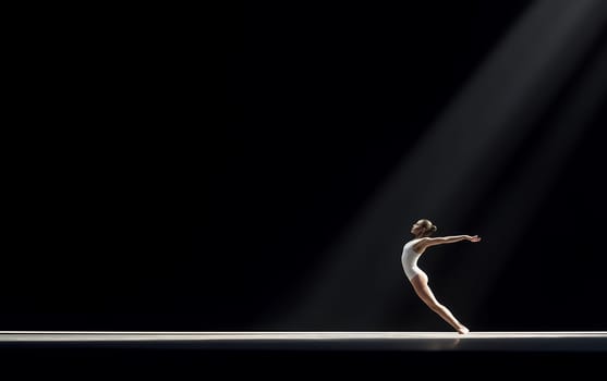 A lone dancer elegantly poses under a spotlight on a dark stage, creating a dramatic performance scene.