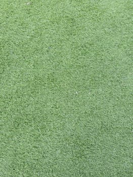Detailed image of synthetic grass with vibrant green texture, perfect for backgrounds, sports fields, or landscaping projects, conveying a clean and lush appearance.