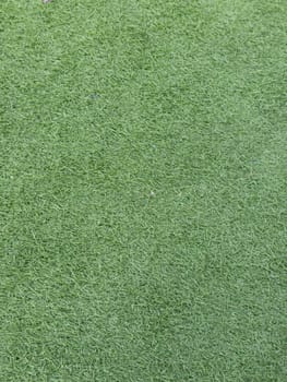 Detailed image of synthetic grass with vibrant green texture, perfect for backgrounds, sports fields, or landscaping projects, conveying a clean and lush appearance.