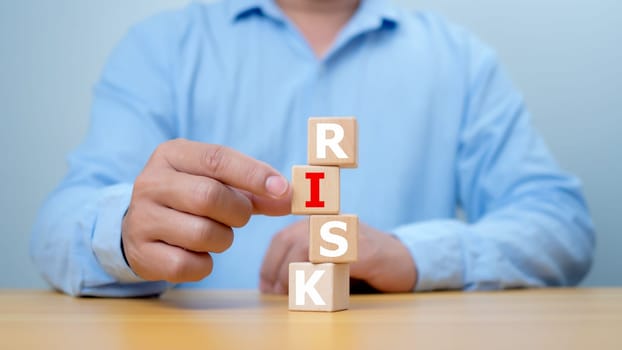 Risk management concept, RISK word print on wooden block on coins money with up arrow and percent for financial banking increase interest rate or investment dividend from, Investment Safety.