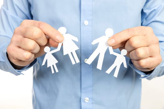 man separating paper family chain, representing divorce, separation, child custody