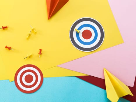 flat lay paper targets with pins paper planes. High resolution photo