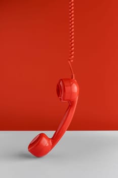 front view telephone receiver hanging from cord. High resolution photo