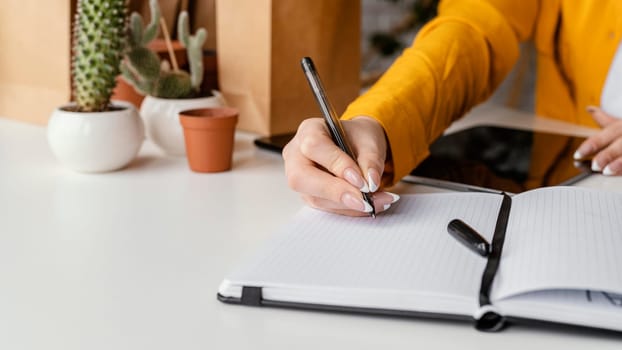 gardener taking notes blank notebook. High resolution photo
