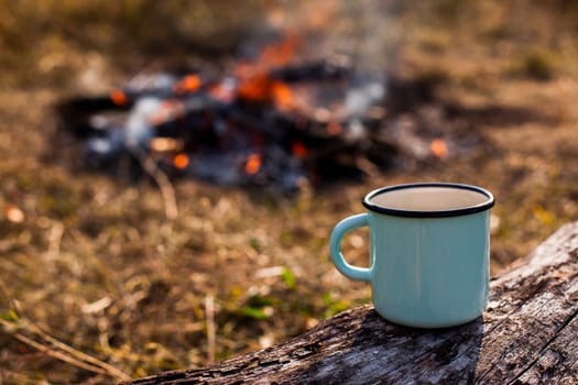 focused blue cup coffee burned out campfire. High resolution photo