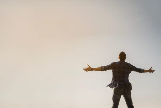 man with open arms looking sky. High resolution photo