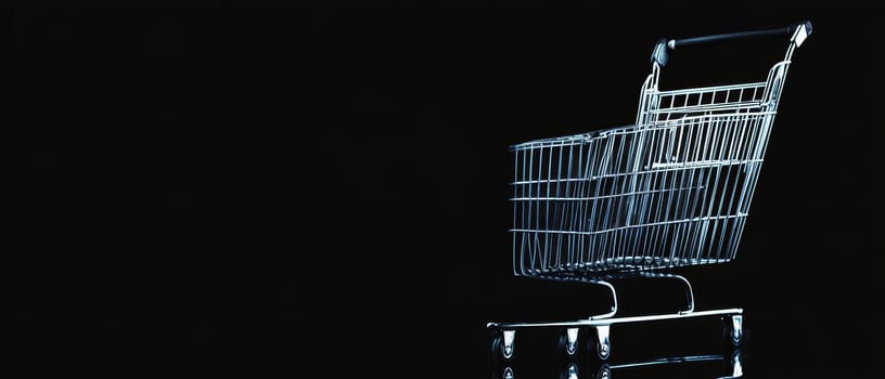 A sleek silver shopping cart in a dark setting, perfect for modern retail concepts with copy space.