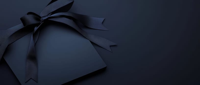 Sophisticated navy blue gift box with a matching ribbon bow, placed on a dark background. Luxurious presentation with ample space for text, ideal for high-end product or event marketing.
