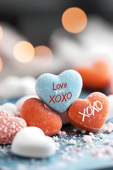 close-up of valentine's day candy hearts in red and white, featuring sweet messages like "xoxo"" and ""love you"" on a soft blue background. AI generated image"